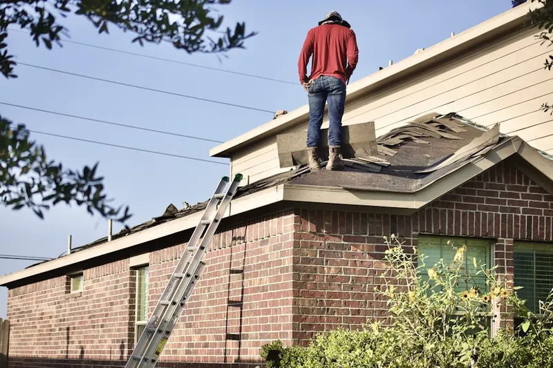Professional roofer working on a residential roof in Gold River